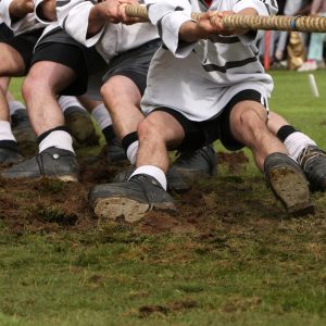 Tug of war is an old traditional game where two teams compete by pulling a rope in a show of strength.